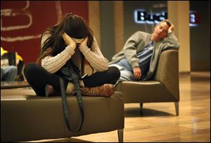 Shoppers rest on chairs in the Fashion Show mall in Las Vegas on Black Friday.