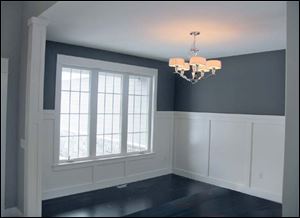 The formal dining room’s tall wainscoting is classic. 