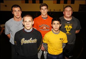 Perrysburg wrestling team. Back from left: Kadin Llewellyn, Rocco Caywood and Cale Bonner. Front row; J.P. Newton, left, and Mario Guillen, right.