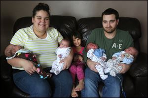 Laura and Bill Baldwin with their children, from left: Reghan, Madalyn, Leah, Logan, and Ryan in their Swanton apartment. The babies were born on Sept. 8; Leah will be 4 on Jan. 8.