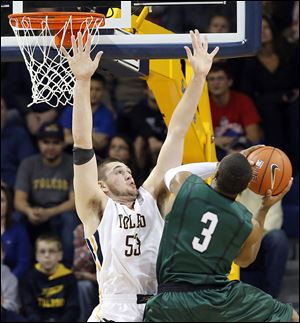 Toledo’s Nathan Boothe, left, defends against   Cleveland State’s Trey Lewis. Boothe finished with 14 points and eight rebounds, while Lewis led CSU with 21 points.