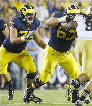 Michigan’s Michael Schofield, left, has turned into one of the leaders for the Wolverines.