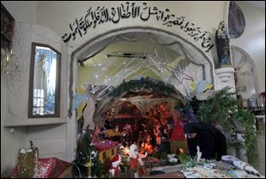Palestinian Christian nun Rosaria, prepares a Nativity scene at the Latin Patriarch of Jerusalem Church of Visitation, also known as St. Mary's Visitation Church, in preparation for Christmas in the northern West Bank village of Zababdeh near Jenin,
