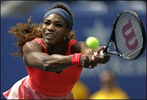 Serena Williams returns a shot to Galina Voskoboeva, of Kazakhstan, during the second round of the 2013 U.S. Open tennis tournament, in New York in August.
