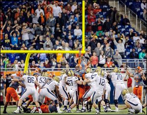 University of Pittsburgh kicker Chris Blewitt (12) kicks the game-winning field goal against Bowling Green State University during the Little Caesars Pizza Bowl on Thursday at Ford Field. The Falcons finish the season 10-4 and 0-1 for interim head coach Adam Scheier.