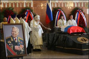 Russian Orthodox Church Metropolitan Yuvenaly conducts a service during a memorial service for Russian firearm designer Mikhail Kalashnikov on Friday in Moscow.