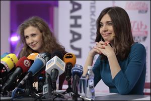 Russian punk band Pussy Riot members Nadezhda Tolokonnikova, right, and Maria Alekhina smile during their news conference Friday in Moscow.