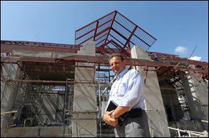 Marc H. Dumur, a Swiss national and veteran hotelier who will manage a new Swiss-owned, 8.7-acre resort-like facility for Alzheimer's patients, poses in front of the under construction main building of the $10-million care project in Chiang Mai province, northern Thailand.  The project is scheduled to open before mid-2014 as Thailand is poised to attract more Alzheimer’s sufferers from Switzerland and elsewhere.