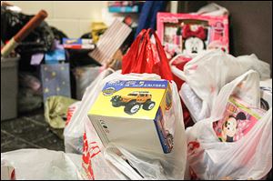 Gifts for central Toledo children pile up during a charity basketball game last month.