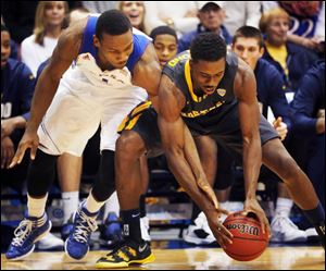 Kansas guard Wayne Selden, left, and Toledo guard Justin Drummond, right, battle for the ball during the first half of an NCAA college basketball game in Lawrence, Kan., Monday.