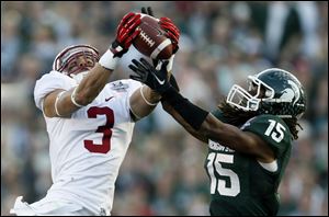 Michigan State cornerback Trae Waynes, right, intercepts a pass intended for Stanford wide receiver Michael Rector during the second half of the Rose Bowl today.