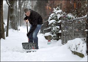 New York City Mayor Bill de Blasio shovels the side- walk in front of his house in New York. New York City public schools were closed after up to 7 inches of snow fell in the Big Apple’s first snowstorm of winter.