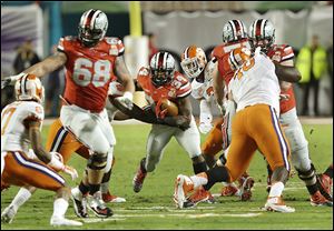 Ohio State running back Carlos Hyde rips off a gain in the first half against Clemson. Hyde’s touchdown in the third quarter put the Buckeyes ahead 29-20, but Ohio State’s defense could not rise to the challenge of shutting down the Tigers.