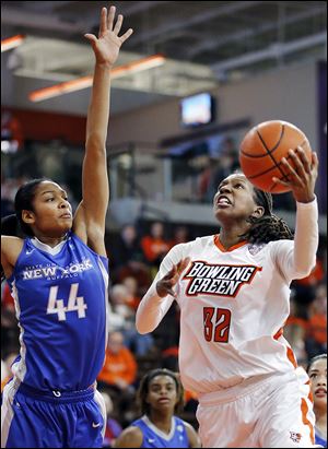 Bowling Green’s Alexis Rogers shoots over Buffalo’s Christa Baccas on Saturday at the Stroh Center. Rogers scored 22 points and grabbed a career-high 17 rebounds as the Falcons won their opening game in MAC play.
