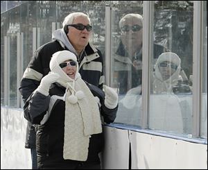 Jack and Celine Kinzler of Trenton, Mich., watch their grandson play for the Southgate Senators during the 5th annual Winter Chill Outdoor Festival at the Ottawa Park Ice Rink in Toledo.