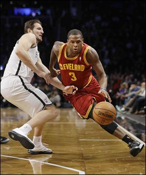 The Cavaliers’ Dion Waiters drives past Brooklyn’s Mirza Teletovic on Saturday night. Waiters led Cleveland with 26 points.