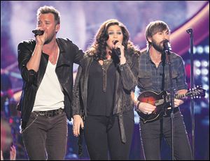 From left, Charles Kelley, Hillary Scott and Dave Haywood, of the musical group Lady Antebellum. The trio will be in Toledo on Jan. 11.