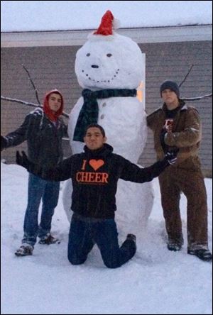 Bryce Wright, Julian Arriaga, and Alex Vargo built a snowman in Gibsonburg.