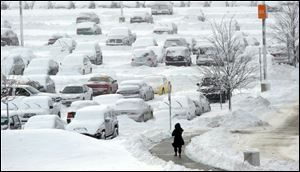 A woman walks back to her car in the long term parking lot at Indianapolis International Airport, Monday.