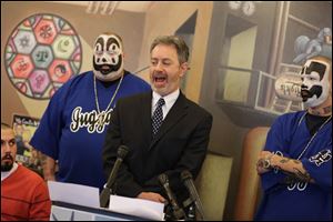 Insane Clown Posse members flank Michael Steinberg, legal director of the ACLU of Michigan, who announced that the ACLU has filed suit over an FBI report that describes the rap-metal duo’s fans  as dangerous.