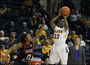 UT's Andola Dortch hits her last jumper in the game to put UT up by four with less than a minute left in the second period. At left is Northern Illinois' Danny Pulliam.