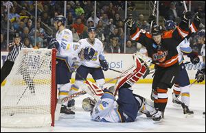 Ft. Wayne Komets player Christian Ouellet (52) celebrates after scoring a goal on Toledo Walleye goalie Mac Carruth (31) during the second period of their hockey game at the Huntington Center, Friday, Jan. 10, 2014.