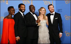 From left, Lupita Nyong'o, Chiwetel Ejiofor, Steve McQueen, Sarah Paulson, and Michael Fassbender pose in the press room with the Golden Globes' top honor, best film drama, for '12 Years a Slave' on Sunday night.