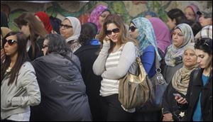 Egyptian voters line up outside a polling station in Cairo today.