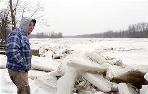 Brett Gillespie looks over the ice jam behind his Wood County home on the Maumee River, off State Rt. 65 near Range Line Road.
