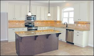 The kitchen colors blend together and highlight the airy feeling of this home.