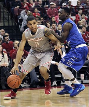 Ohio State's Marc Loving dribbles against Central Connecticut's Matt Mobley. The freshman is averaging 6.6 points and is the latest in a long line of Toledo talent to play for the Buckeyes.