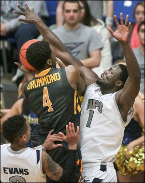 Toledo’s Justin Drummond drives against Akron’s Demetrius Treadwell. Drummond was limited to four points for the Rockets.