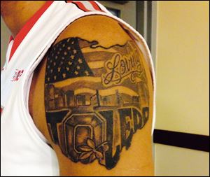 Marc Loving, a St. John’s graduate, wears his love for Toledo and Ohio State every day. His Ohio-shaped tattoo includes Ohio State's ‘Block O’ as part of the spelling of his hometown.