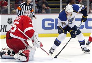 Detroit Red Wings goalie Jimmy Howard stops a St. Louis Blues wing T.J. Oshie (74) shot in the first period Monday in Detroit.
