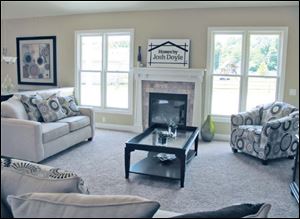 This comfortable great room includes a Craftsman-style fireplace.