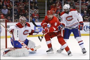Detroit Red Wings left wing Justin Abdelkader (8) tries to redirect a shot against Montreal Canadiens goalie Carey Price (31) as P.K. Subban (76) defends in the second period of an NHL hockey game, Friday, Jan. 24, 2014, in Detroit.