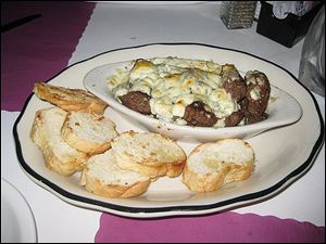 Beef tips with melted blue cheese and toasted bread rounds BJ's Hide-A-Way  in Oregon.