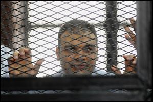 Mohammed Badr, a cameraman for Al-Jazeera Mubasher Misr, appeared at a court in Cairo, Egypt in December.  Egypt’s chief prosecutor has referred 20 journalists who work for the Qatar-based Al-Jazeera network, including four foreigners, to a criminal trial.
