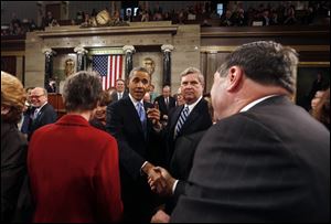 President Barack Obama shakes hands as he leaves after giving the State of Union address before a joint session of Congress in the House chamber Tuesday in Washington.