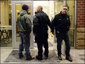 K-9 Officer Phil Lerza, left, joined by fellow K-9 Officer Tim Crane, far right, held a vigil for Rocco as he was taken from a  Pittsburgh veterinary center.