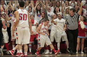 Eastwood senior Michael Flipse, center, celebrates a layup against Lake. Flipse finished the night with 12 points and six assists.