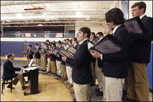 Nick Dombi, Jack Dowd, and Ethon Pawlaczyk, from left, are among singers at a Mass in which eight students at St. Francis de Sales High School were ‘knighted.’