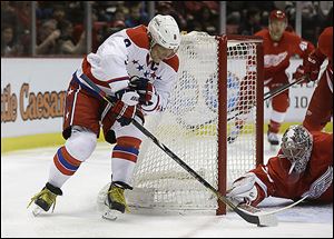 Red Wings goalie Jimmy Howard stops a wrap-around attempt by Capitals right wing Alex Ovechkin during the first period.