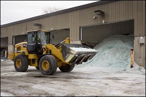 Road salt is unloaded from storage at the public works facility in Glen Ellyn, Ill. The Midwest's recent severe winter weather has caused communities to expend large amounts of their road salt supplies.