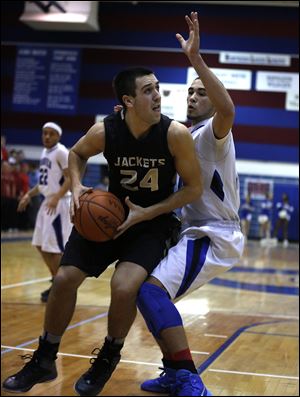 Perrysburg 6-foot-3 senior Nick Moschetti is guarded by Springfield’s Manny Durden. Moschetti leads the Northern Lakes League in scoring at 21.6 points per game and averages 6.4 rebounds.