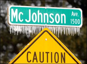 Icicles cling to the McJohnson Avenue street sign Wednesday in Owensboro, Ky.