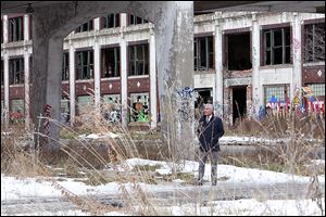 A  developer from Lima, Peru, tours  the abandoned  Packard Motors plant  in Detroit in this January photo. The long-vacant plant has become an international symbol of urban decay. 