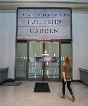 Lisa Reyerse looks at the door leading into the Tuileries exhibit. The exhibit is a collaborative effort by museums in Toledo, Atlanta, and Portland, Ore., and Paris.