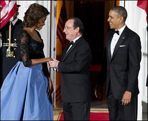 First Lady Michelle Obama and President Obama welcome French President Francois Hollande, center, to the White House last week.