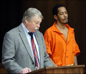 Curtis McDuffey, Jr., 31, of Toledo, charged with involuntary manslaughter for the beating death of a Toledo taxi driver, appears in Toledo Municipal Court with public defender James MacHarg today.